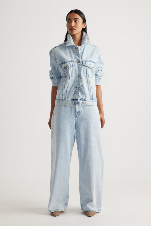 Model wearing Elena Wide Leg Jean in light denim paired with matching denim jacket showcasing effortless Decjuba style