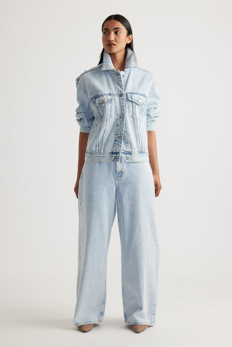 Model wearing Elena Wide Leg Jean in light denim paired with matching denim jacket showcasing effortless Decjuba style