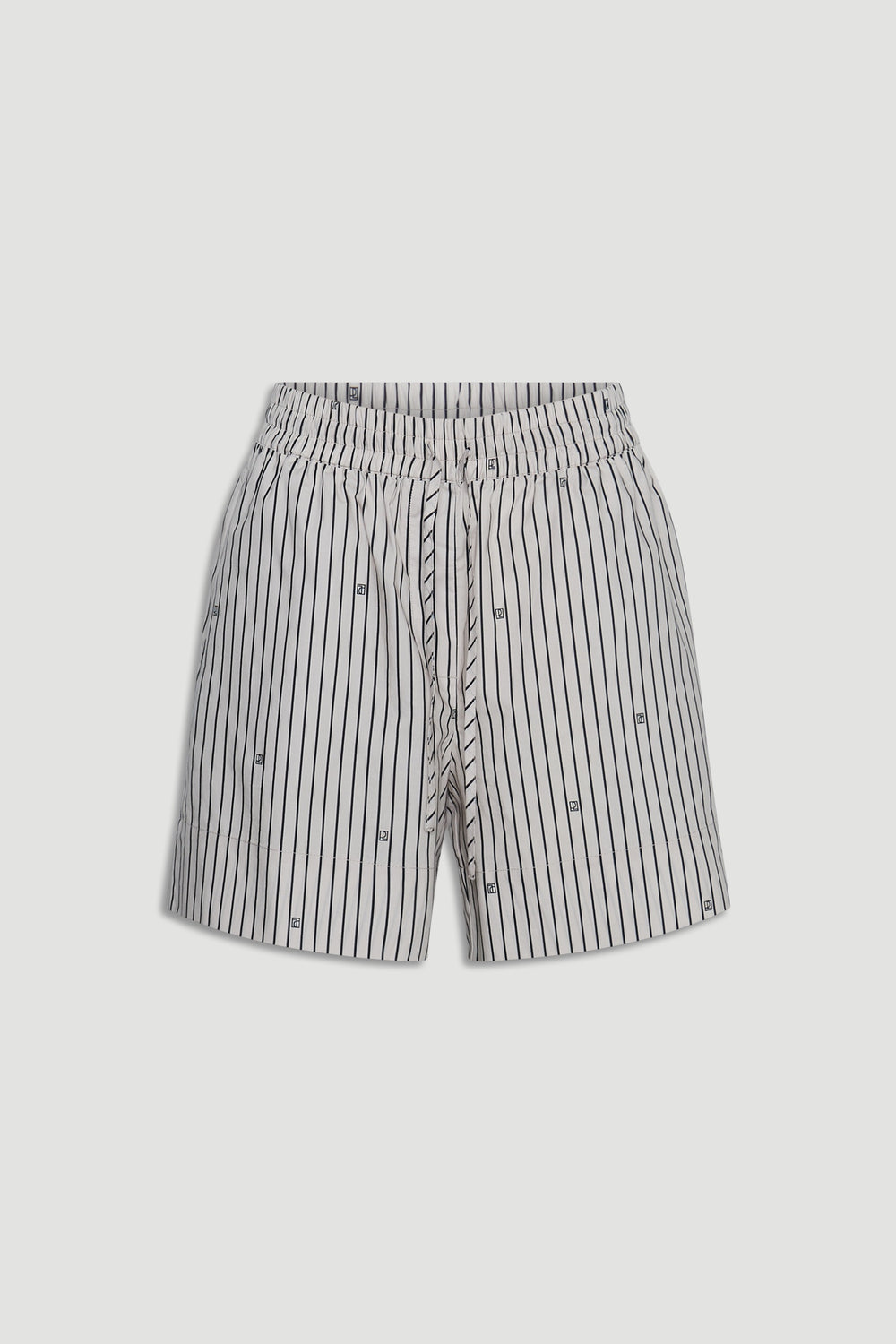 Light-colored shorts with vertical black stripes and subtle monogram details, featuring a drawstring waist for comfort.