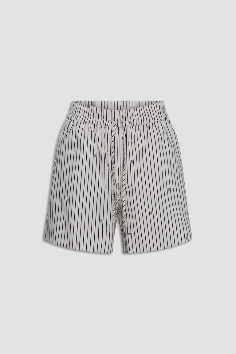 Light-colored shorts with vertical black stripes and subtle monogram details, featuring a drawstring waist for comfort.