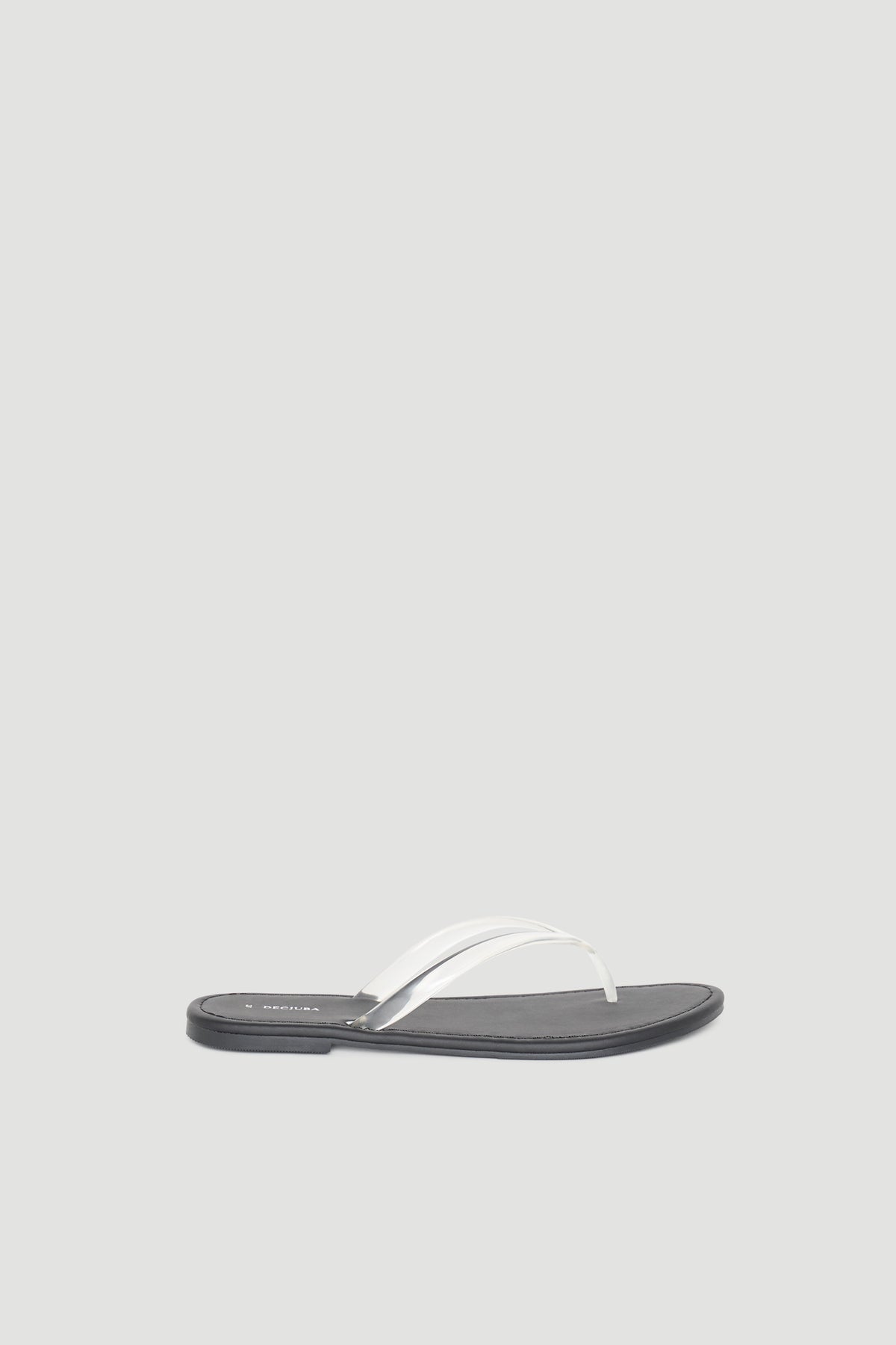 Minimalist black flat thong slide sandal featuring a sleek white strap for effortless everyday wear.