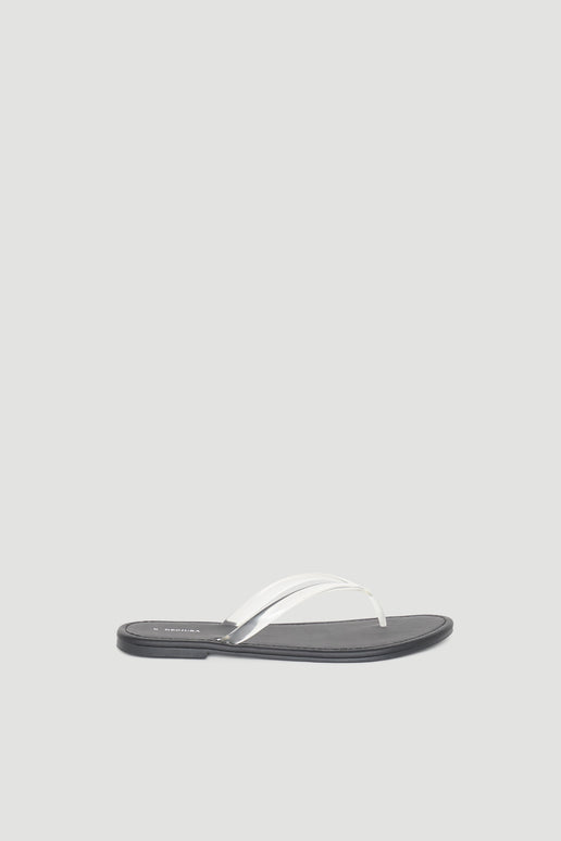 Minimalist black flat thong slide sandal featuring a sleek white strap for effortless everyday wear.