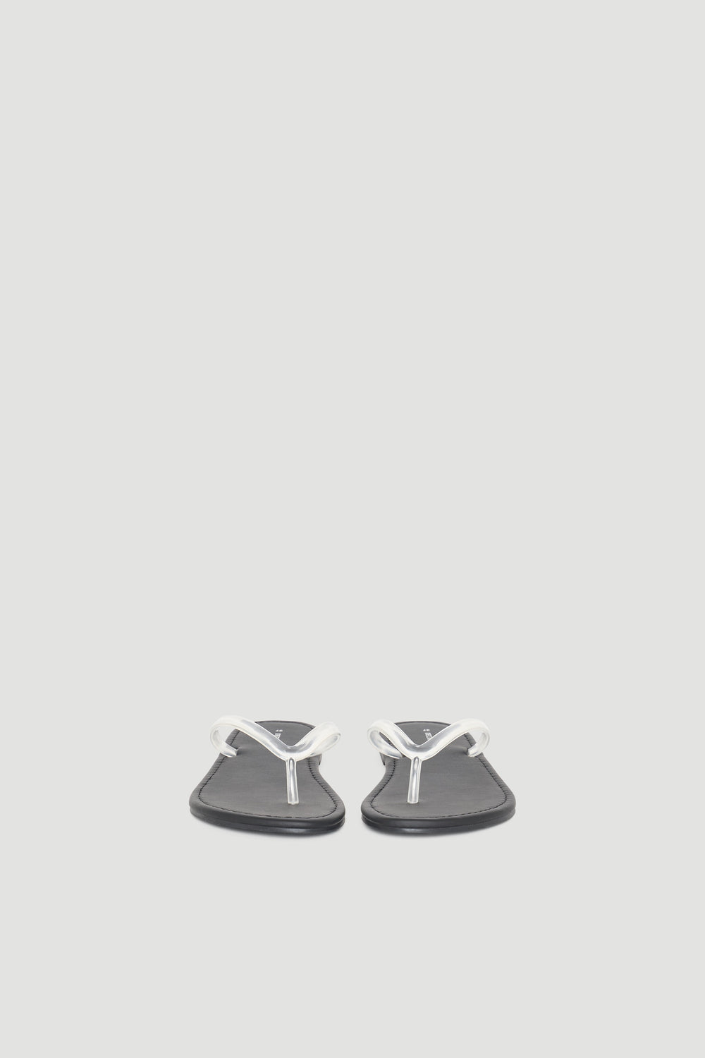 Minimalist black thong slides with sleek white straps, designed for casual everyday comfort and versatile style.