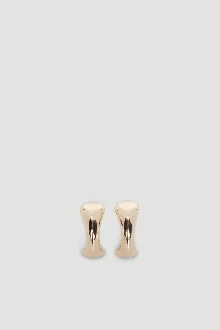 Pair of polished gold-tone abstract hoop earrings with a smooth, modern sculptural design on a neutral background.