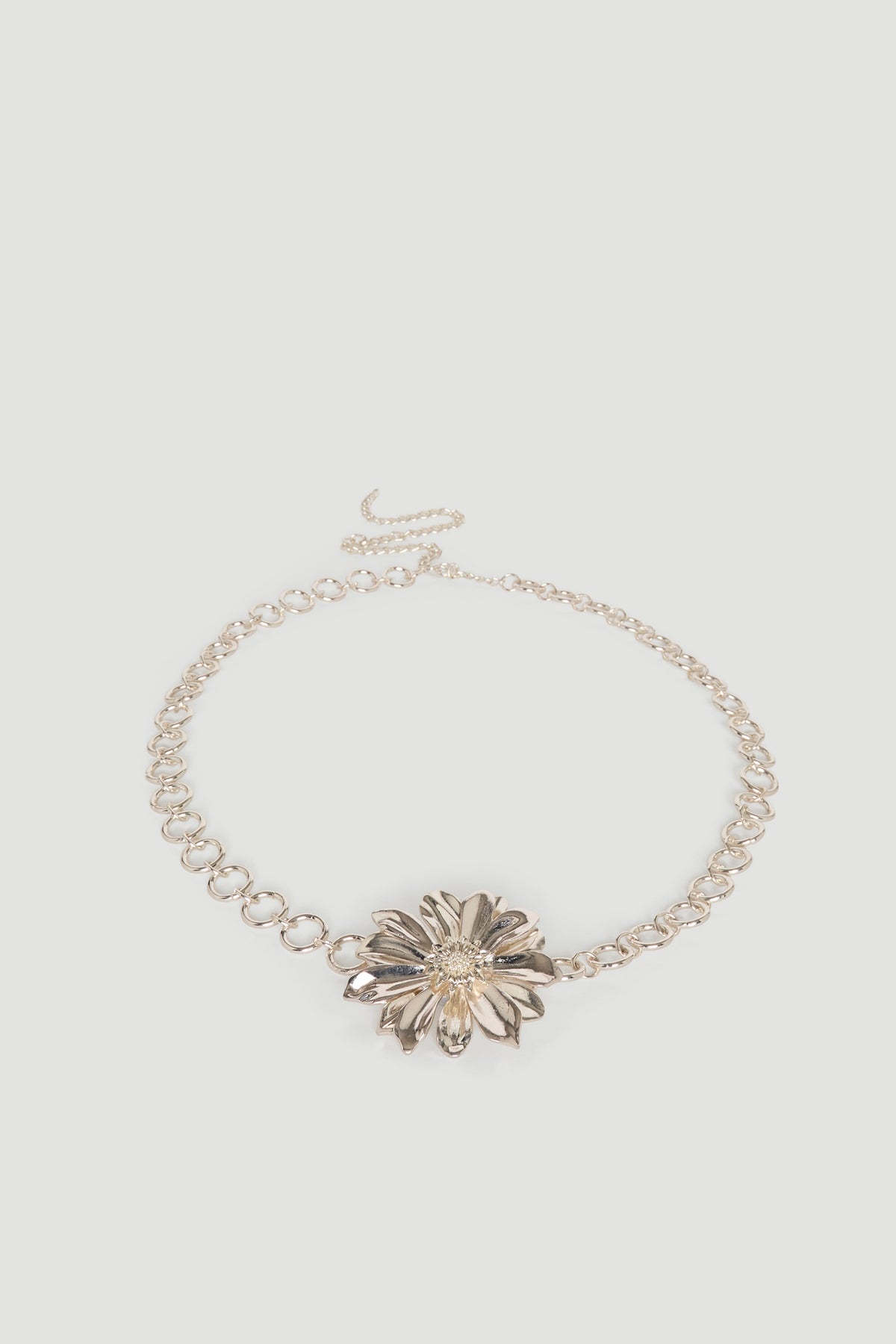 Gold chain belt with statement flower motif and hook closure