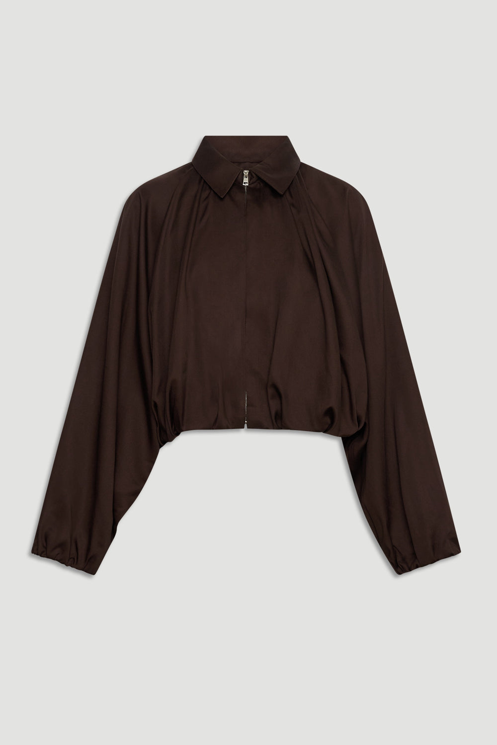 Dark espresso cropped jacket with puffed long sleeves, a collar, and a front zipper for a chic, modern silhouette