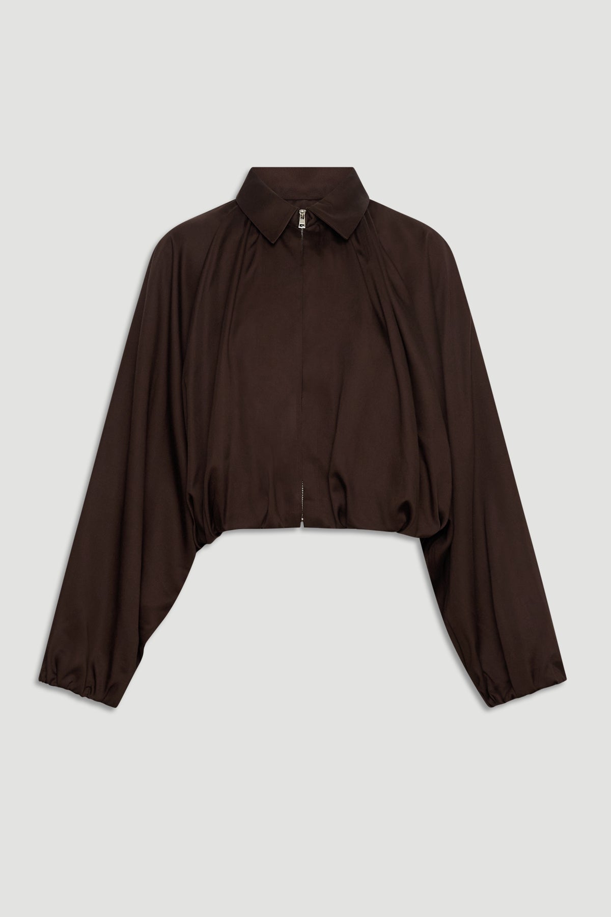 Dark espresso cropped jacket with puffed long sleeves, a collar, and a front zipper for a chic, modern silhouette