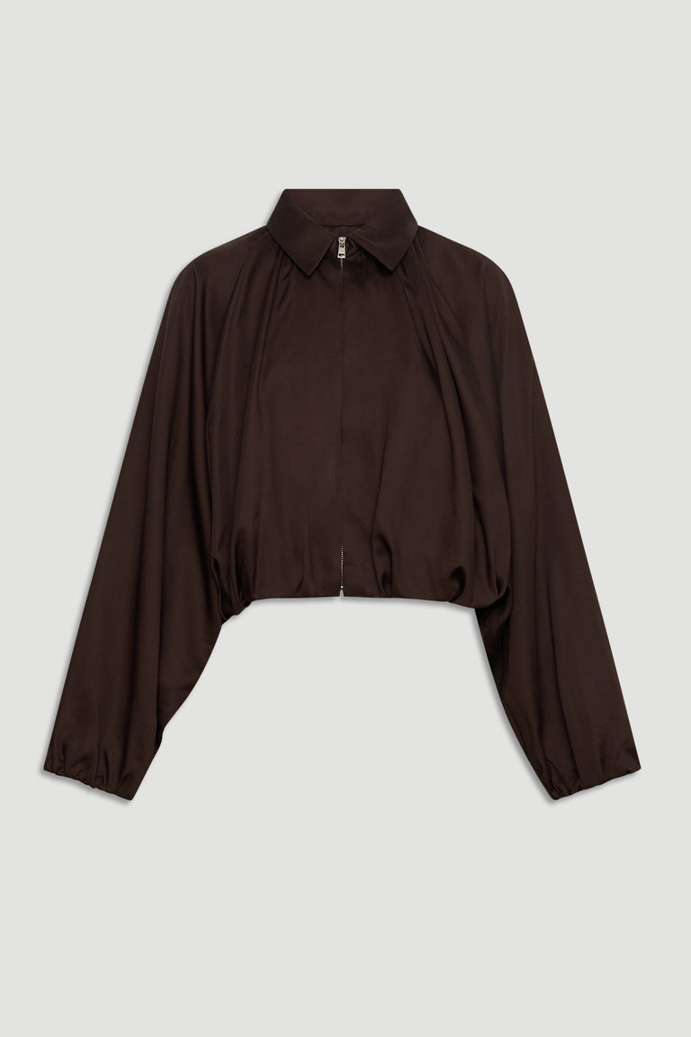 Dark espresso cropped jacket with puffed long sleeves, a collar, and a front zipper for a chic, modern silhouette