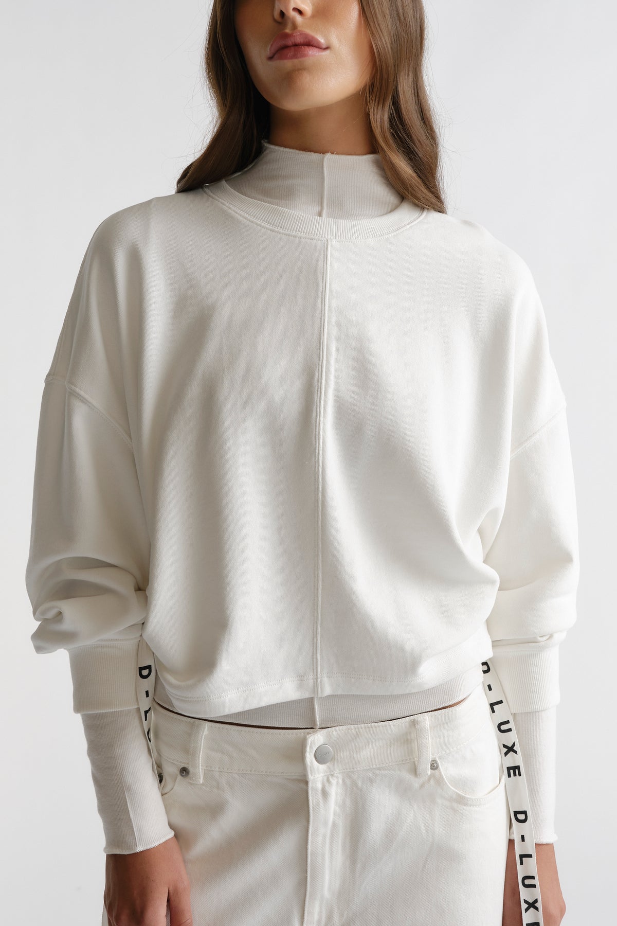 Close-up of ivory D-Luxe Ruched Terry Sweat with relaxed fit and branded side ties for a stylish, comfy look by DECJUBA.