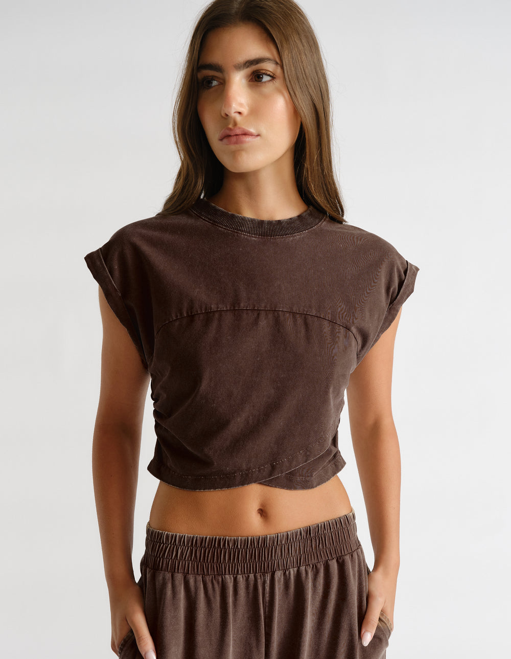 Model wearing brown elastic waist joggers with a matching cropped tee