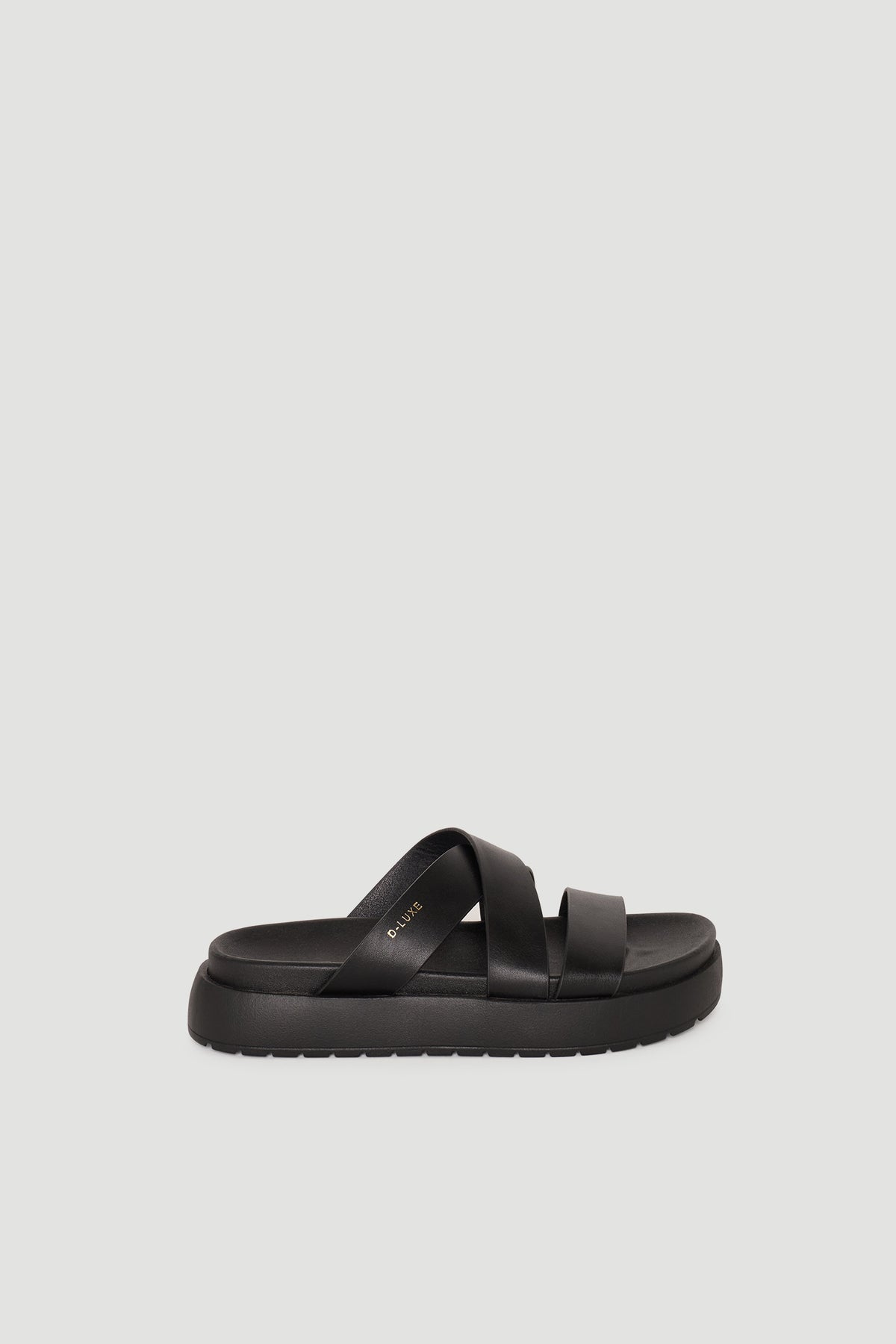 Black platform sandal featuring wide crossover straps and a cushioned sole for easy, stylish comfort.