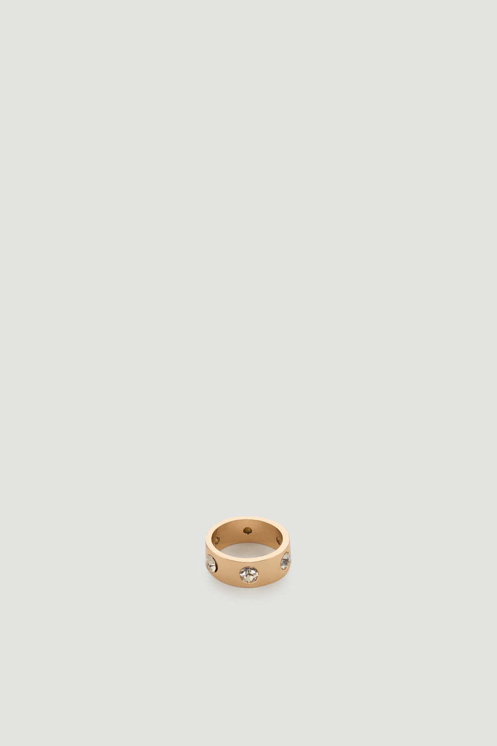 Gold-tone band ring featuring evenly spaced sparkling diamante stones for a chic, modern finish