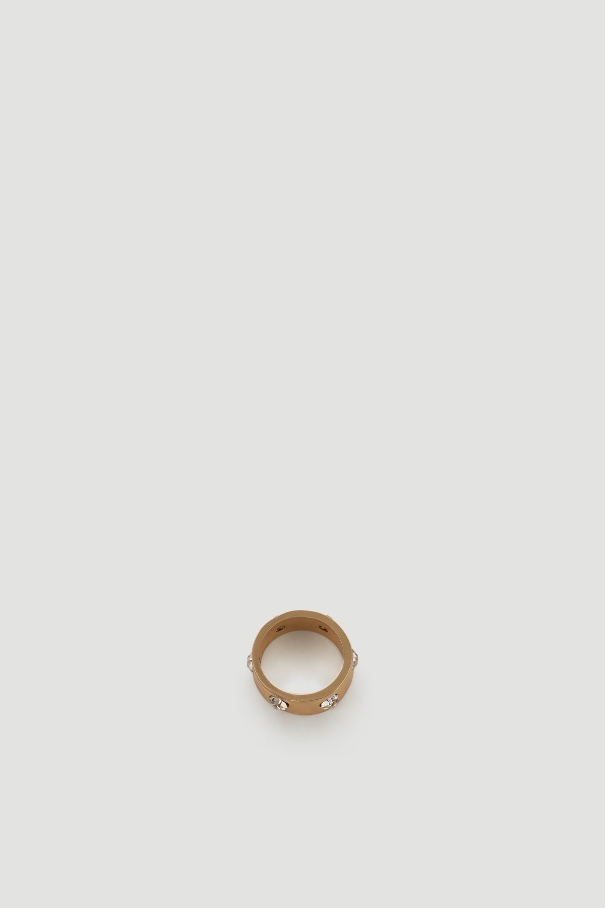 Gold-tone ring with sparkling diamante accents for a subtle yet elegant statement accessory