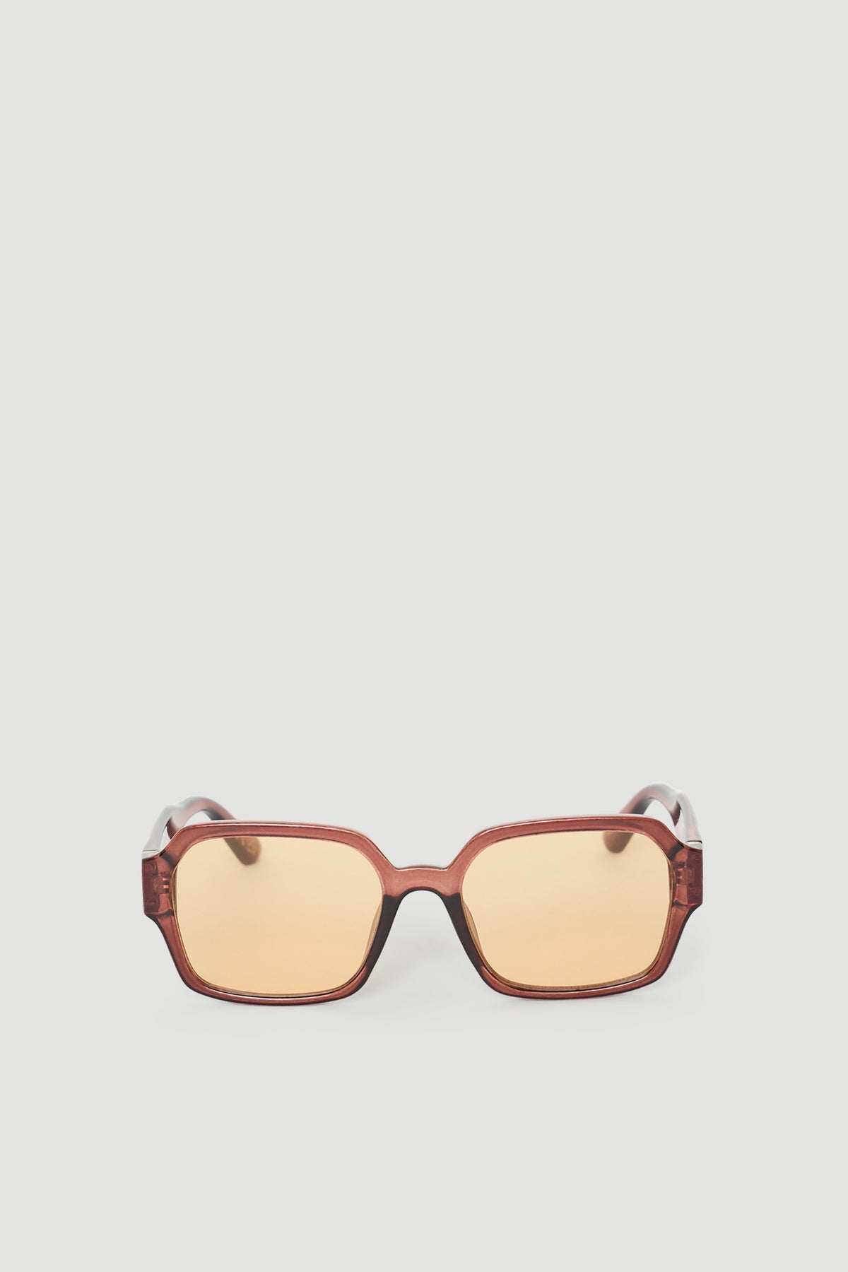 Oversized square sunglasses with warm brown tinted lenses and a translucent amber frame for a stylish look