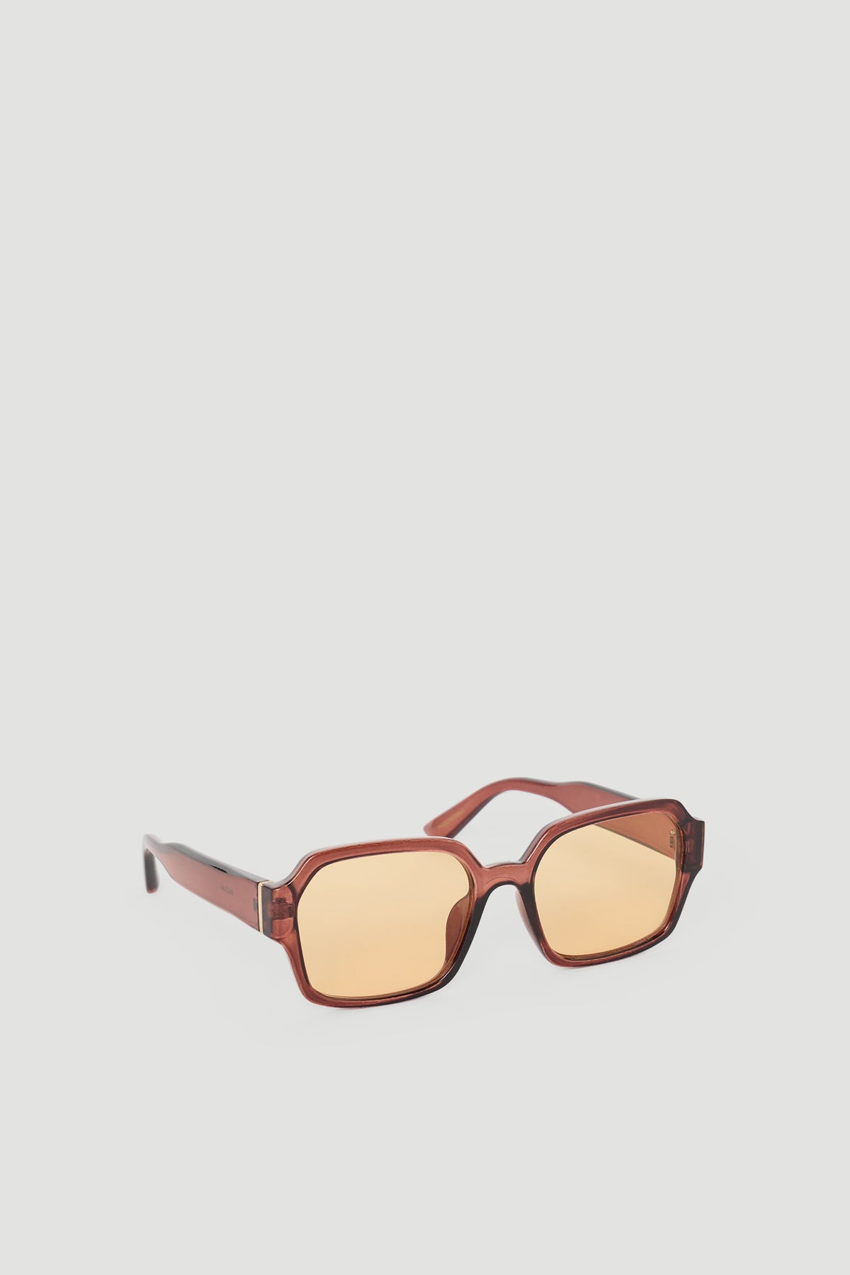 Oversized sunglasses with warm amber lenses and a rich brown frame for a bold, stylish accessory.