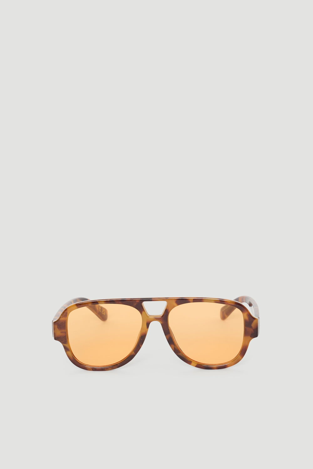 Stylish aviator sunglasses with tortoiseshell frames and warm amber lenses for a modern, versatile accessory.