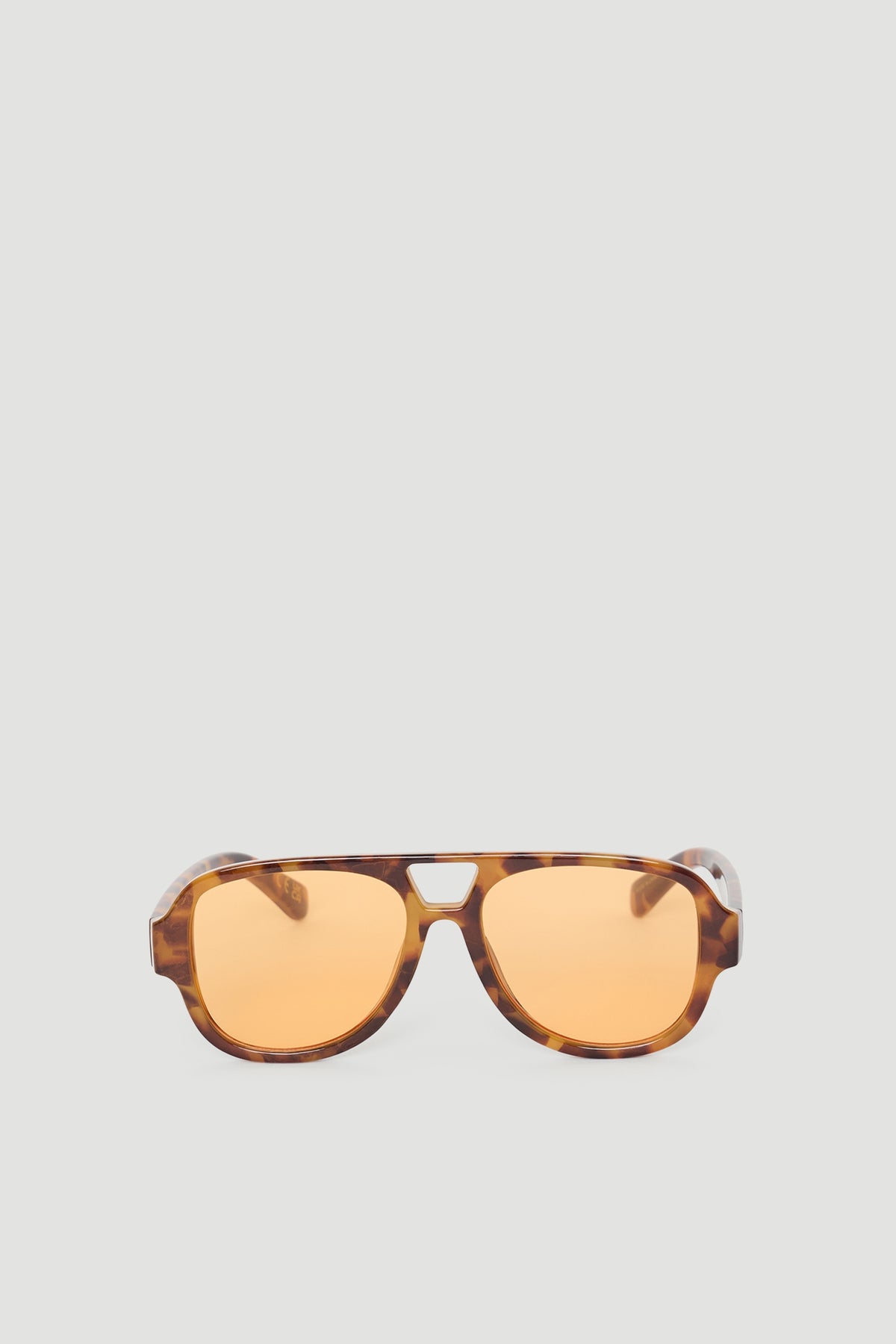 Stylish aviator sunglasses with tortoiseshell frames and warm amber lenses for a modern, versatile accessory.