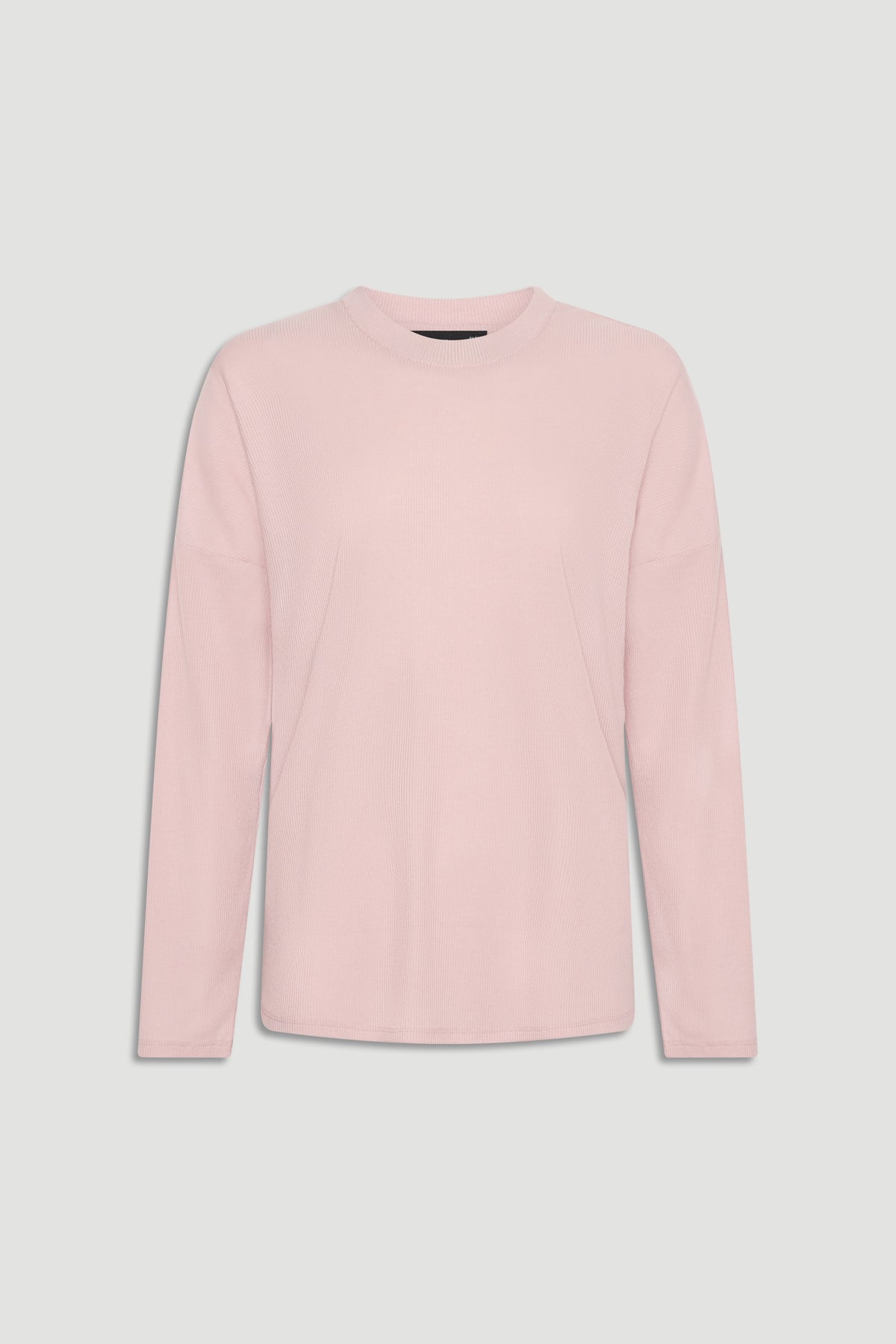 Soft pink long sleeve ribbed top with crew neckline for a versatile, comfortable everyday look