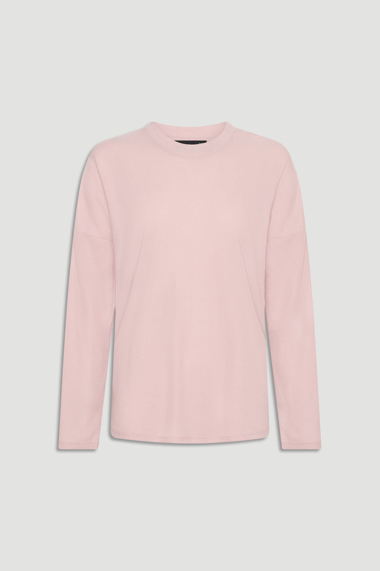 Soft pink long sleeve ribbed top with crew neckline for a versatile, comfortable everyday look