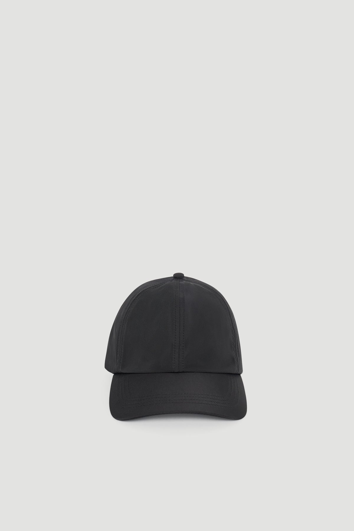 Minimalist black cap with a sleek, smooth finish designed for effortless everyday styling.
