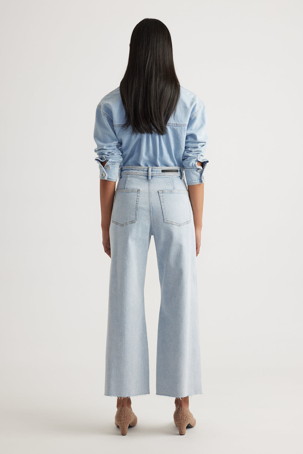 Back view of Tahni Wide Leg Jean in light wash denim with relaxed fit by Decjuba, an Australian fashion brand.