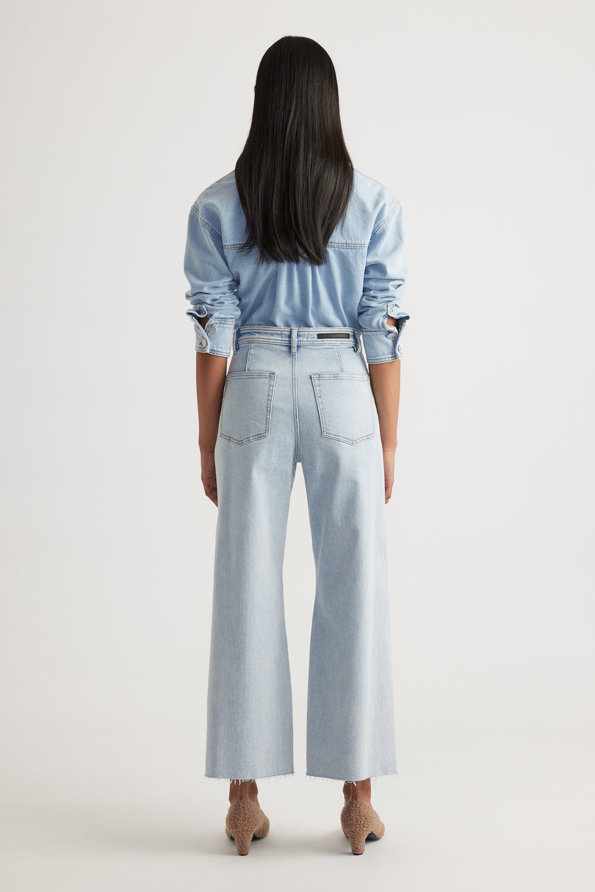 Back view of Tahni Wide Leg Jean in light wash denim with relaxed fit by Decjuba, an Australian fashion brand.