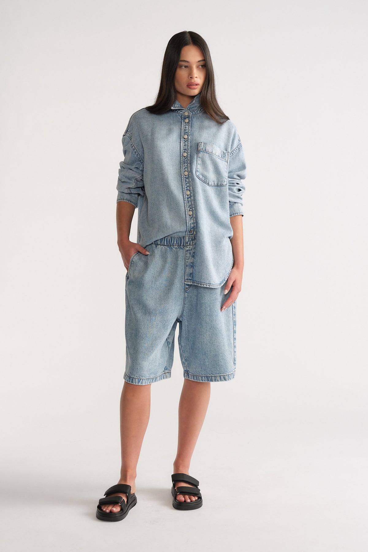 Woman wearing D-Luxe Fluid Denim Short in light wash with relaxed fit, styled casually by Decjuba Australian fashion brand