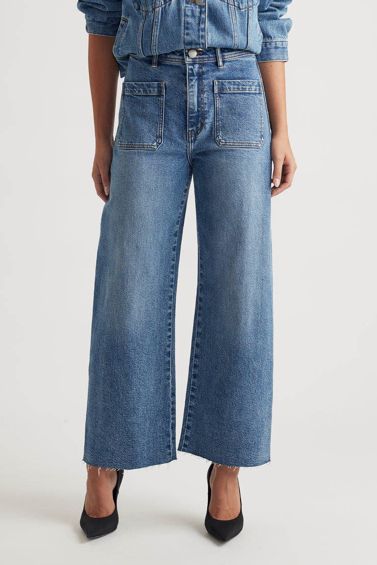 Darcy Cropped Wide Leg Jean in classic blue denim with front patch pockets and raw hem by DECJUBA Australian fashion brand