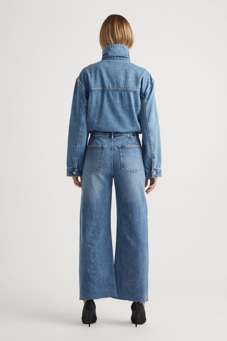 Darcy Cropped Wide Leg Jean in classic blue denim with high waist and raw hem, styled with matching denim jacket by DECJUBA Australian brand