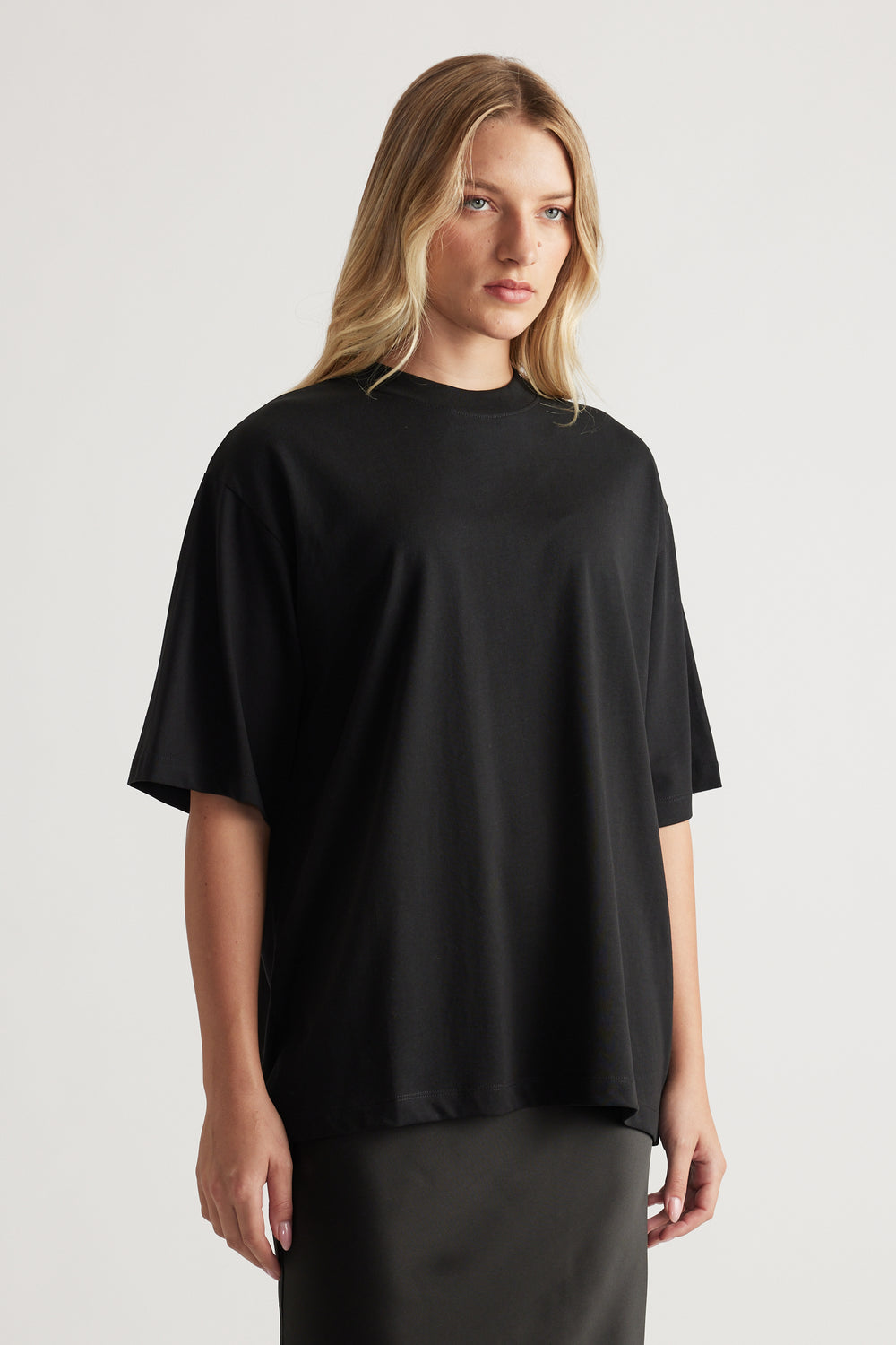 Woman wearing a relaxed fit black oversized tee with short sleeves styled effortlessly for everyday wear
