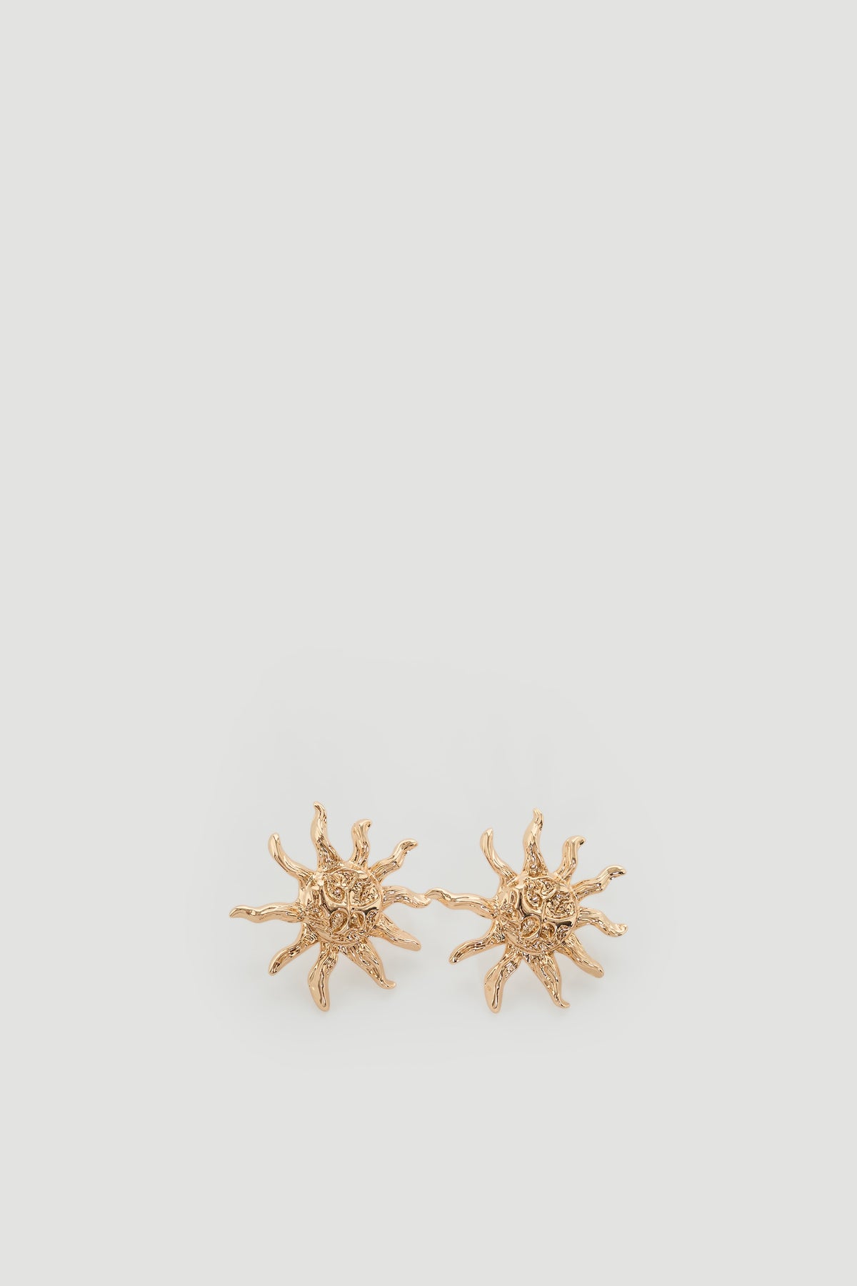 Tara Sun Earrings featuring textured metal sun motif in a detailed close-up, portrait orientation, gallery position 1.