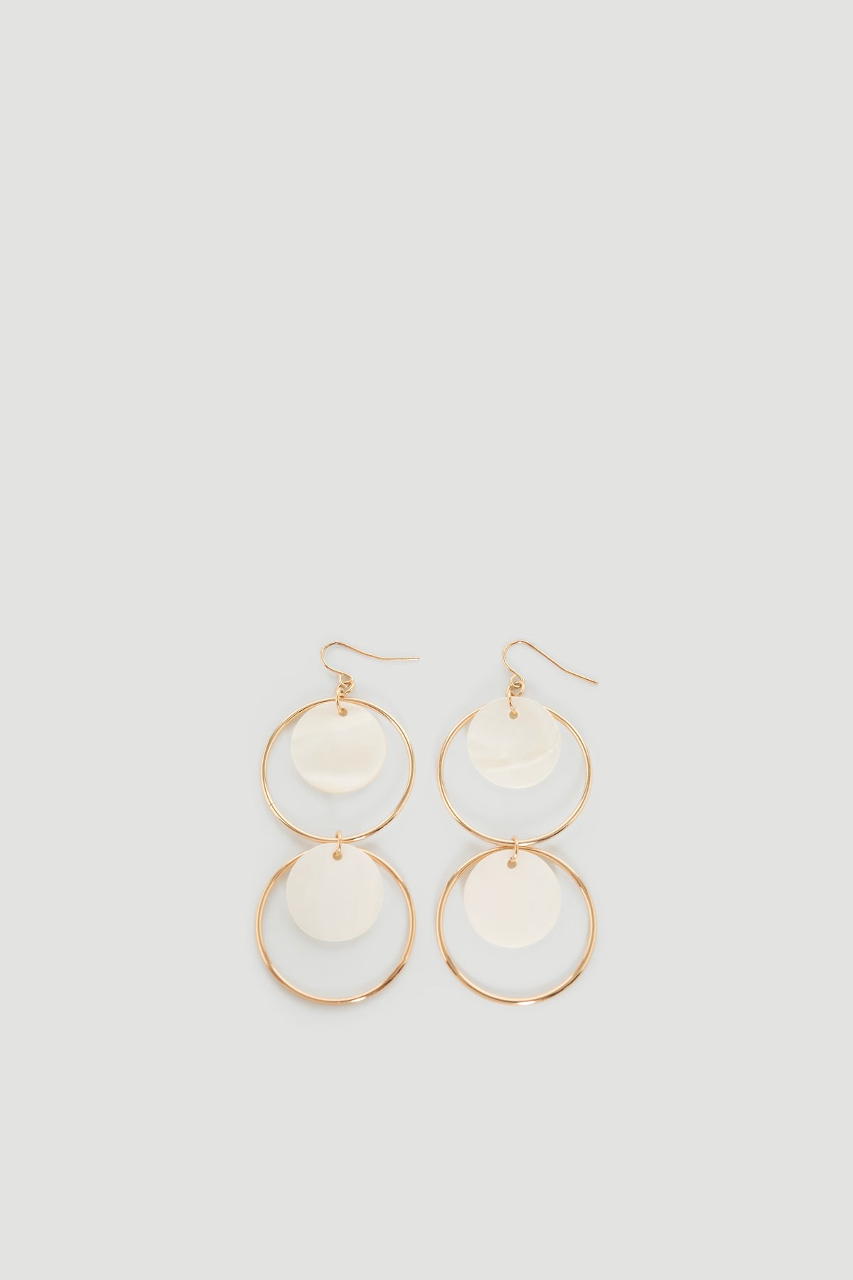 Tina Circle Earrings featuring gold hoops with mother-of-pearl discs, elegant and versatile by DECJUBA Australian fashion brand