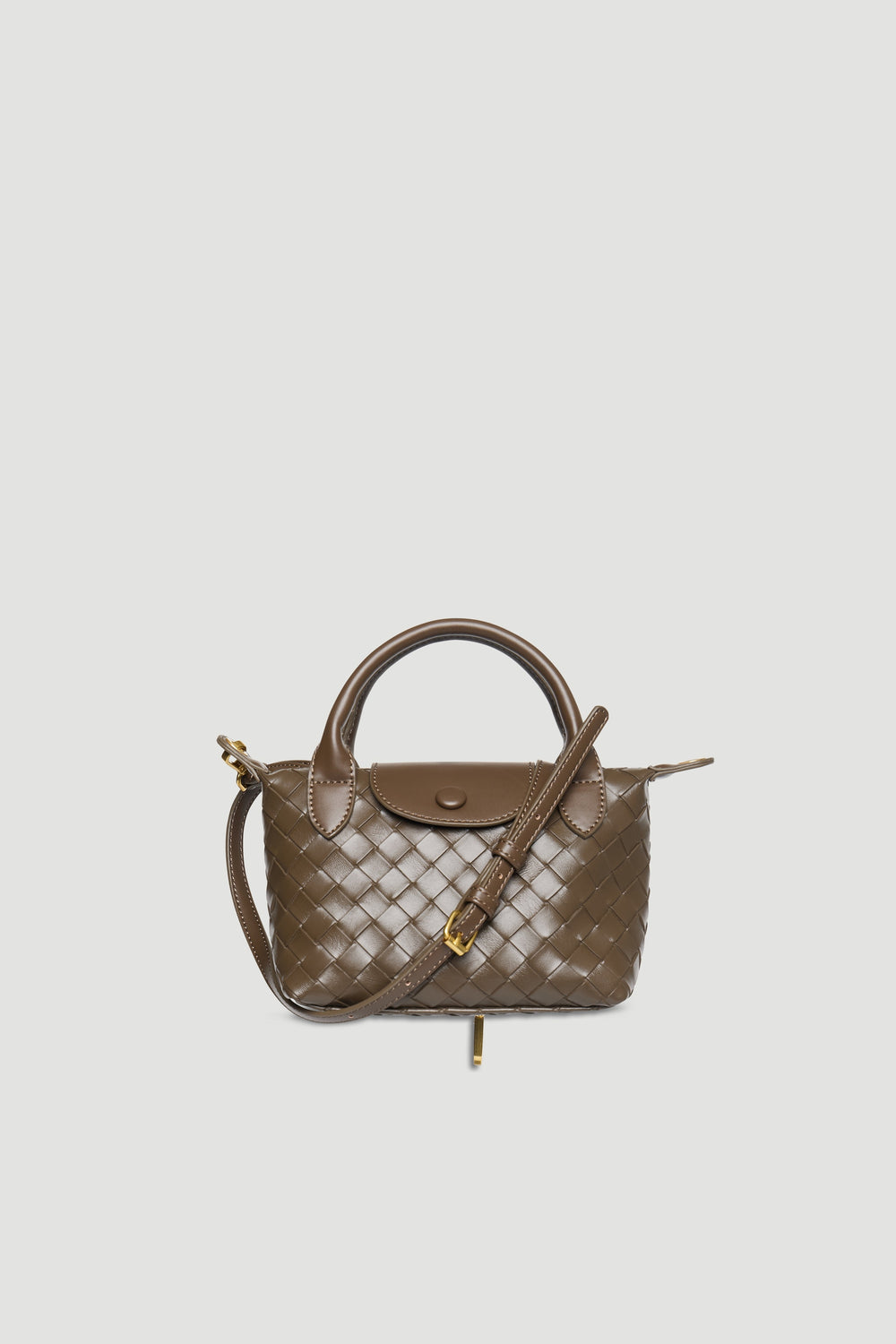 Taupe mini handbag with woven texture, detachable strap, gold hardware, snap button, and zip closure on plain background