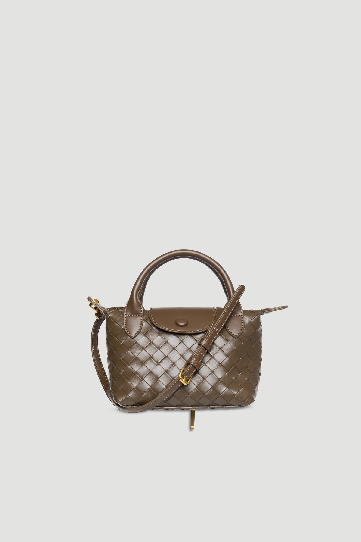 Taupe mini handbag with woven texture, detachable strap, gold hardware, snap button, and zip closure on plain background
