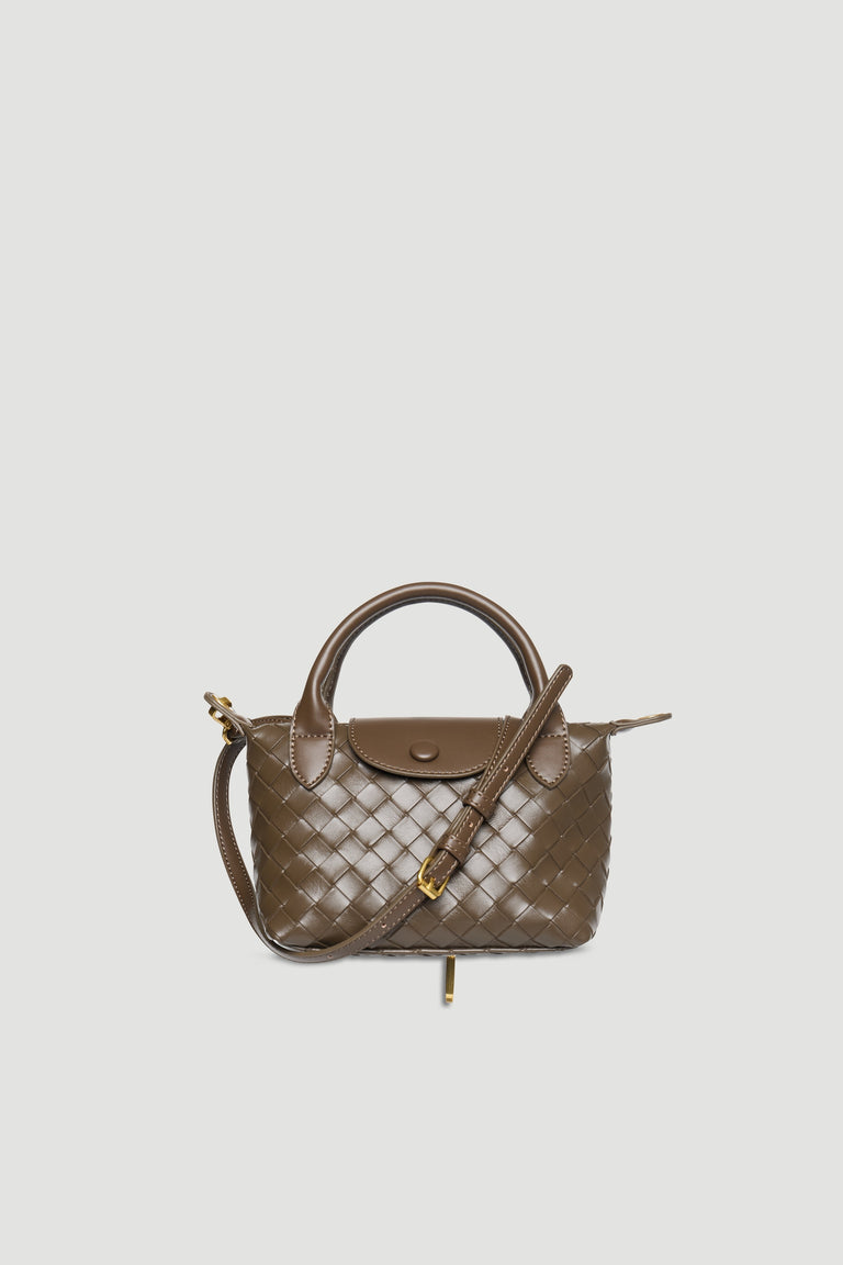 Taupe mini handbag with woven texture, detachable strap, gold hardware, snap button, and zip closure on plain background
