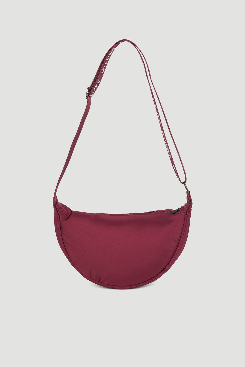 Plum-colored half moon crossbody bag with adjustable strap featuring discreet brand lettering for stylish everyday use