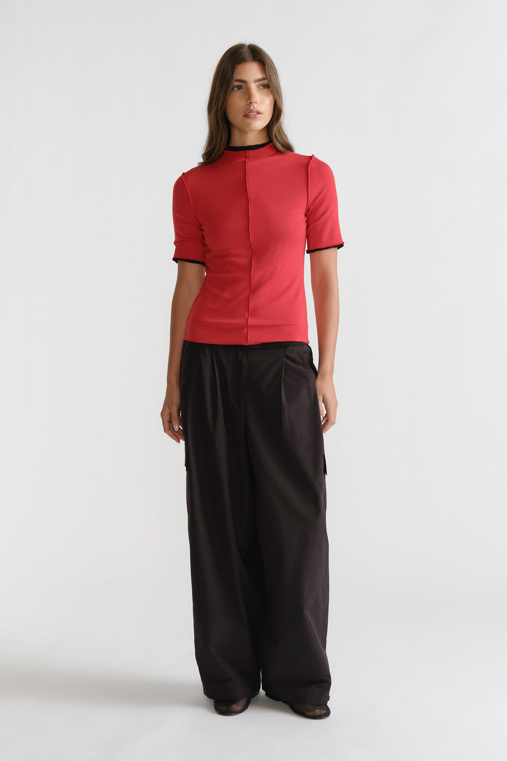 D-Luxe Short Sleeve Top in vibrant red with contrasting trims, sleek fit, styled with wide-leg black pants by DECJUBA Australian fashion brand