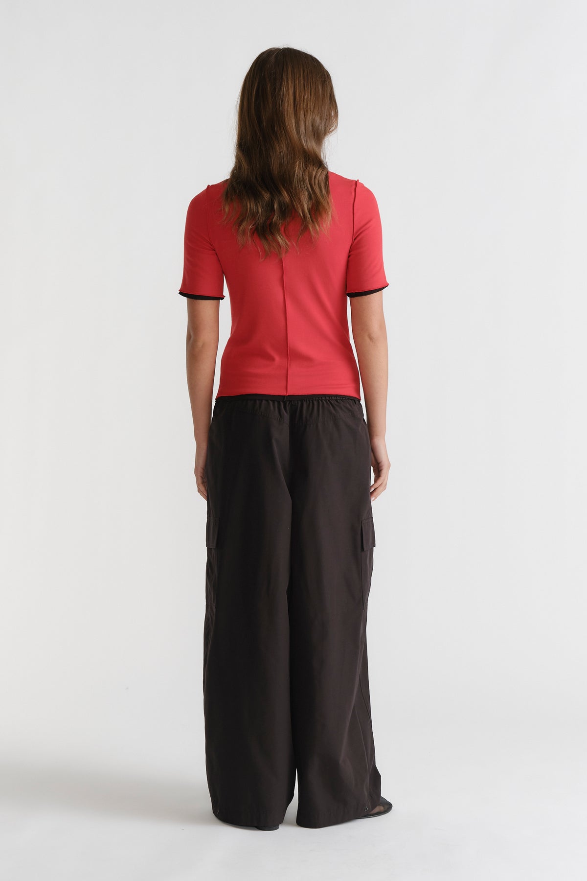 D-Luxe Short Sleeve Top in vibrant red with black trim, slim fit, styled with loose black pants by DECJUBA Australian fashion brand