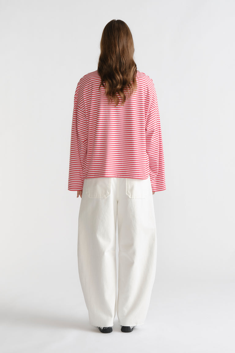 D-Luxe Long Sleeve Stripe Tee in red and white stripes paired with wide-leg white denim trousers by DECJUBA Australian brand