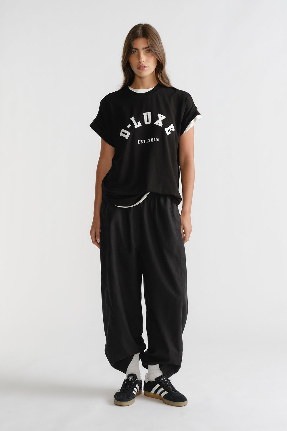 D-Luxe Half Moon Tee in black with white contrast trim worn casually, a versatile style by DECJUBA Australian fashion brand.