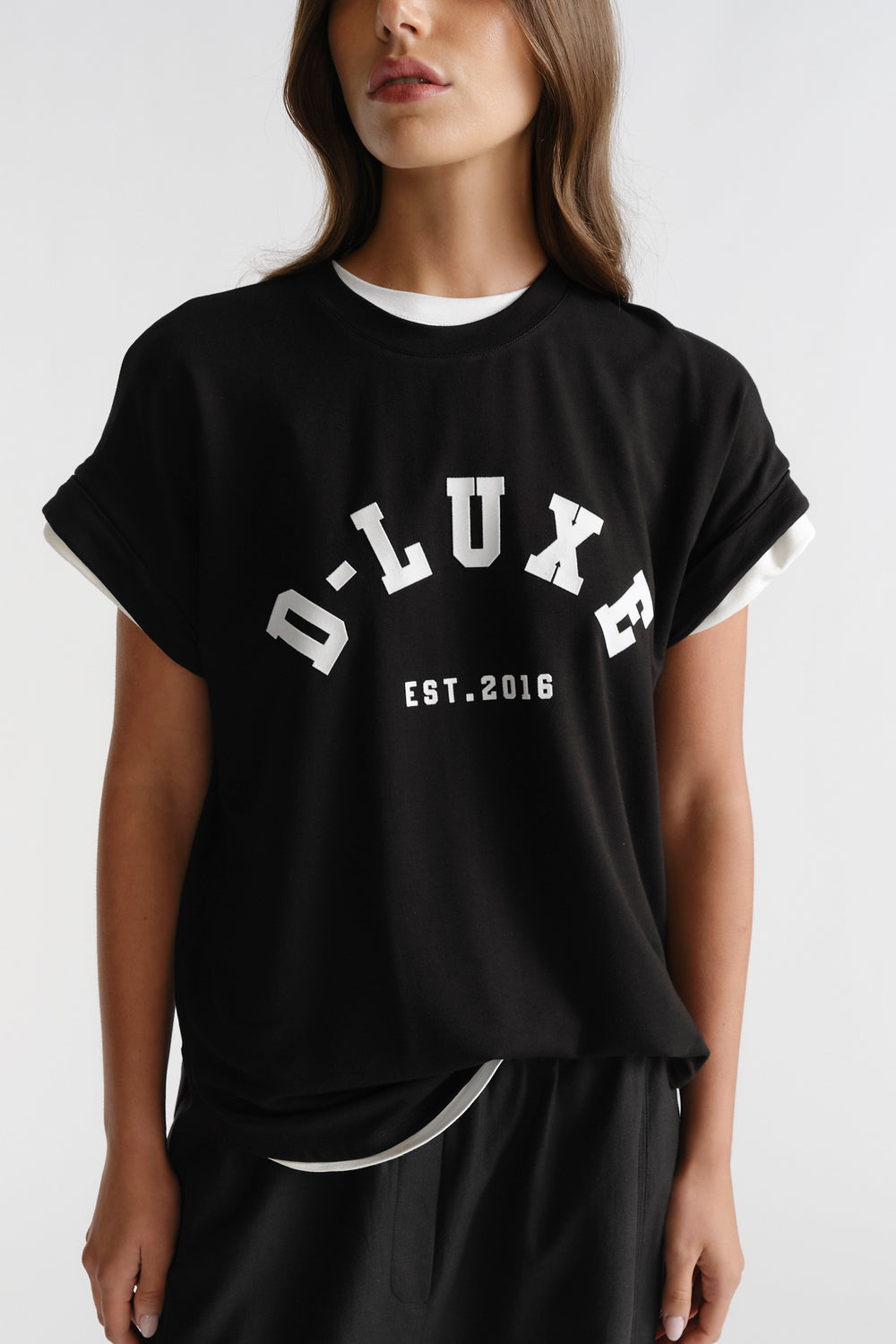 D-Luxe Half Moon Tee in black featuring white contrast logo and rolled sleeves, crafted by DECJUBA Australian fashion brand.