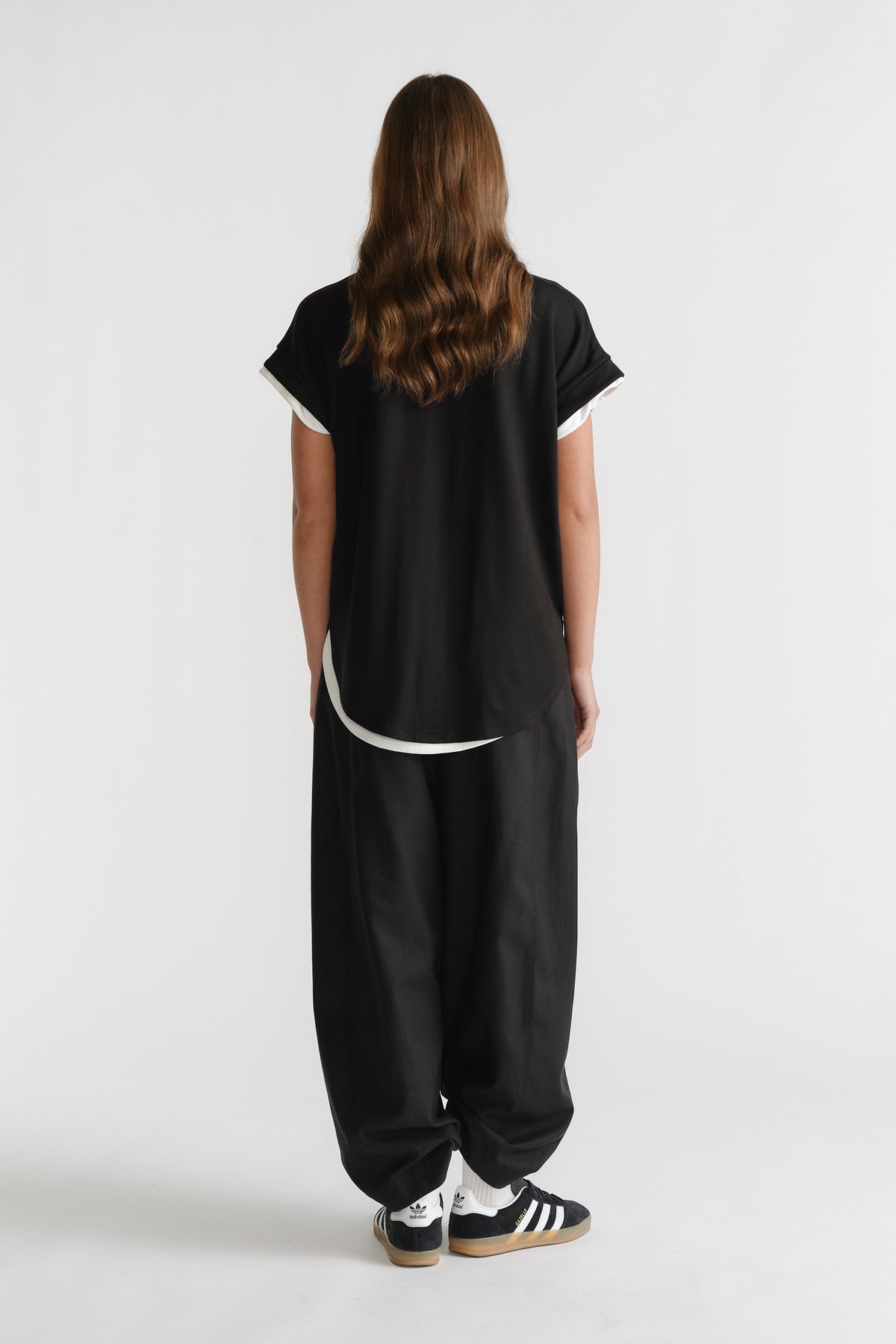 D-Luxe Half Moon Tee in black with white trim at sleeves and hem, styled casually by DECJUBA Australian fashion brand.