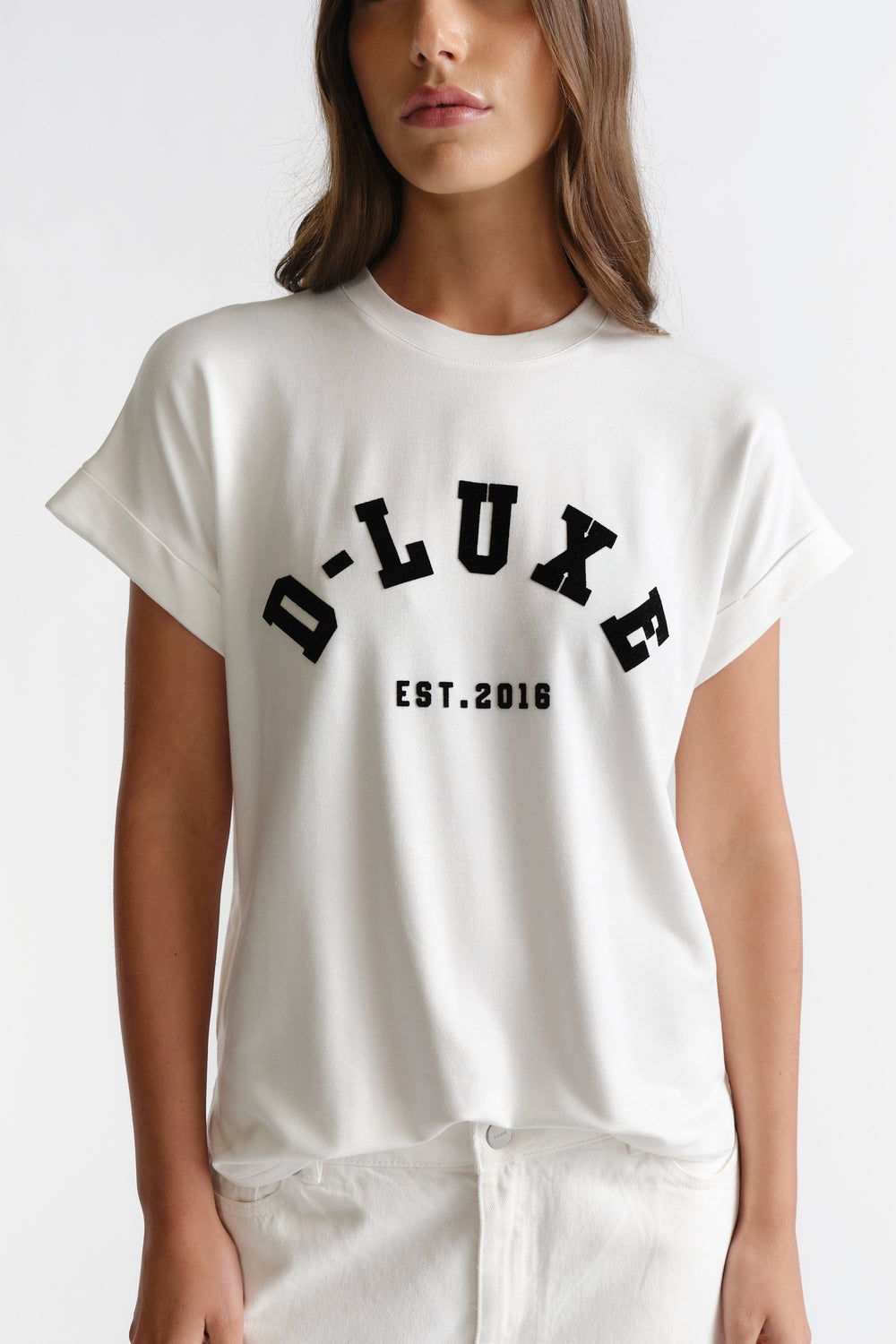 D-Luxe Half Moon Tee in white with bold black lettering, relaxed fit, styled by DECJUBA Australian fashion brand.