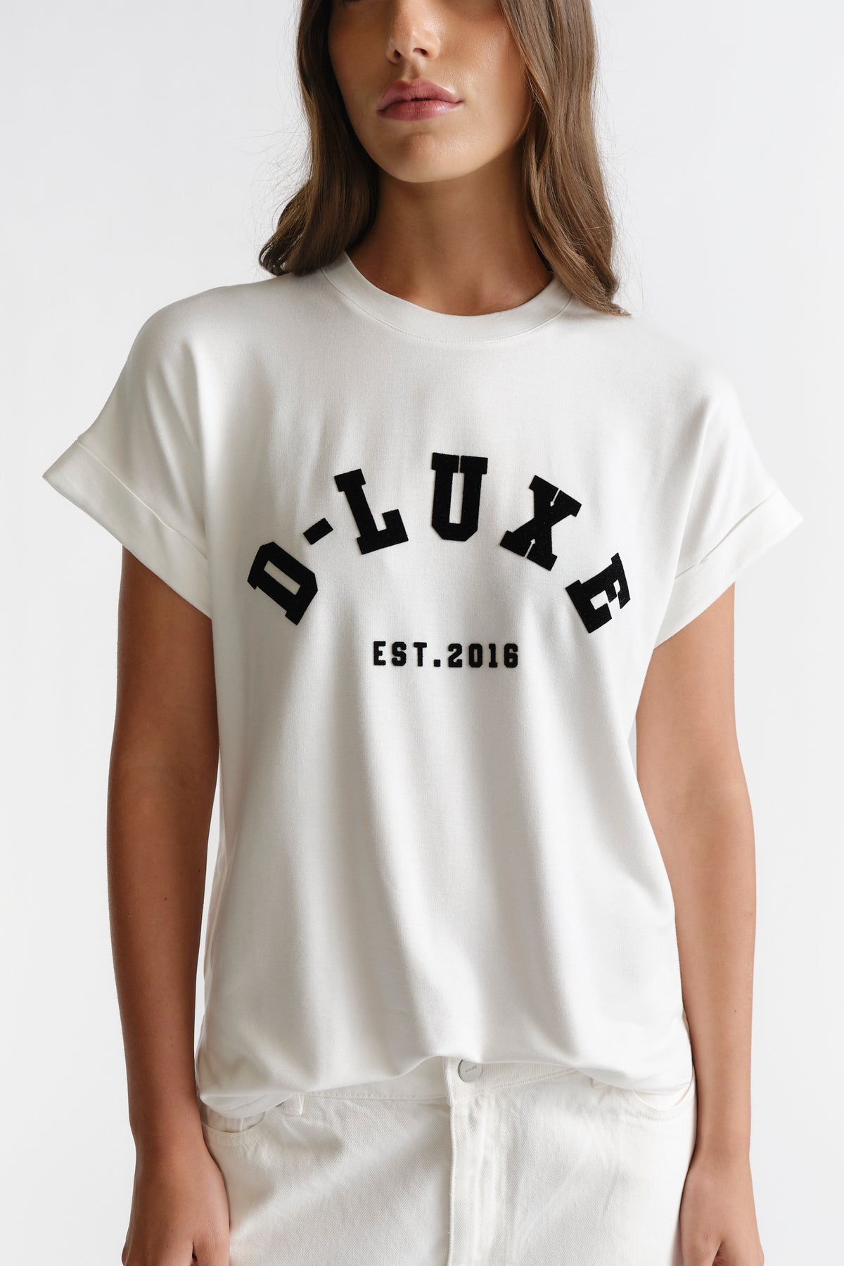 D-Luxe Half Moon Tee in white with bold black lettering, relaxed fit, styled by DECJUBA Australian fashion brand.
