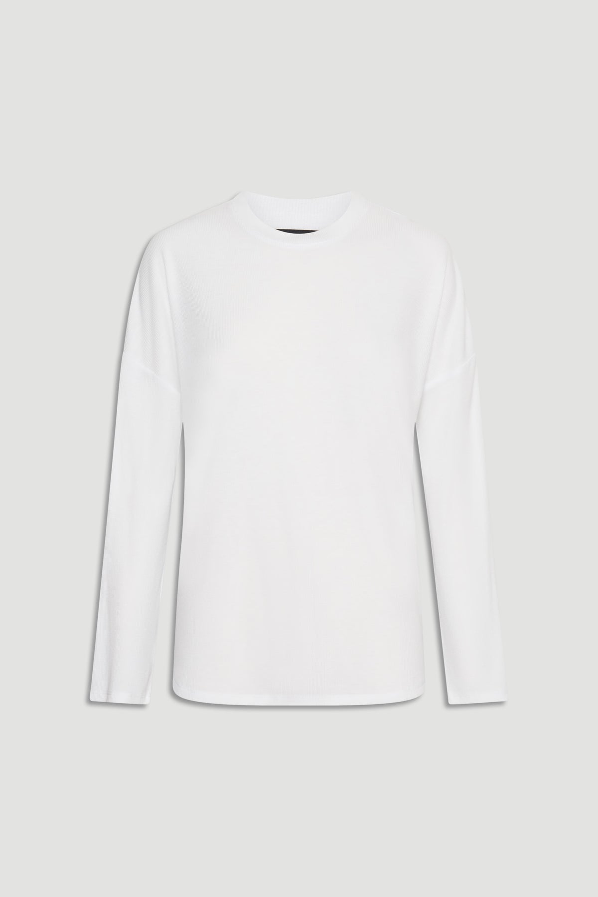Minimalist white long sleeve ribbed top with a relaxed fit, perfect for layering or casual wear.