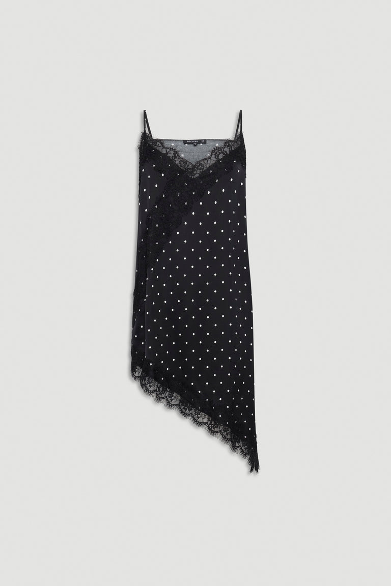 Black asymmetric tunic with white polka dots, delicate lace trim, thin adjustable straps, and soft textured fabric
