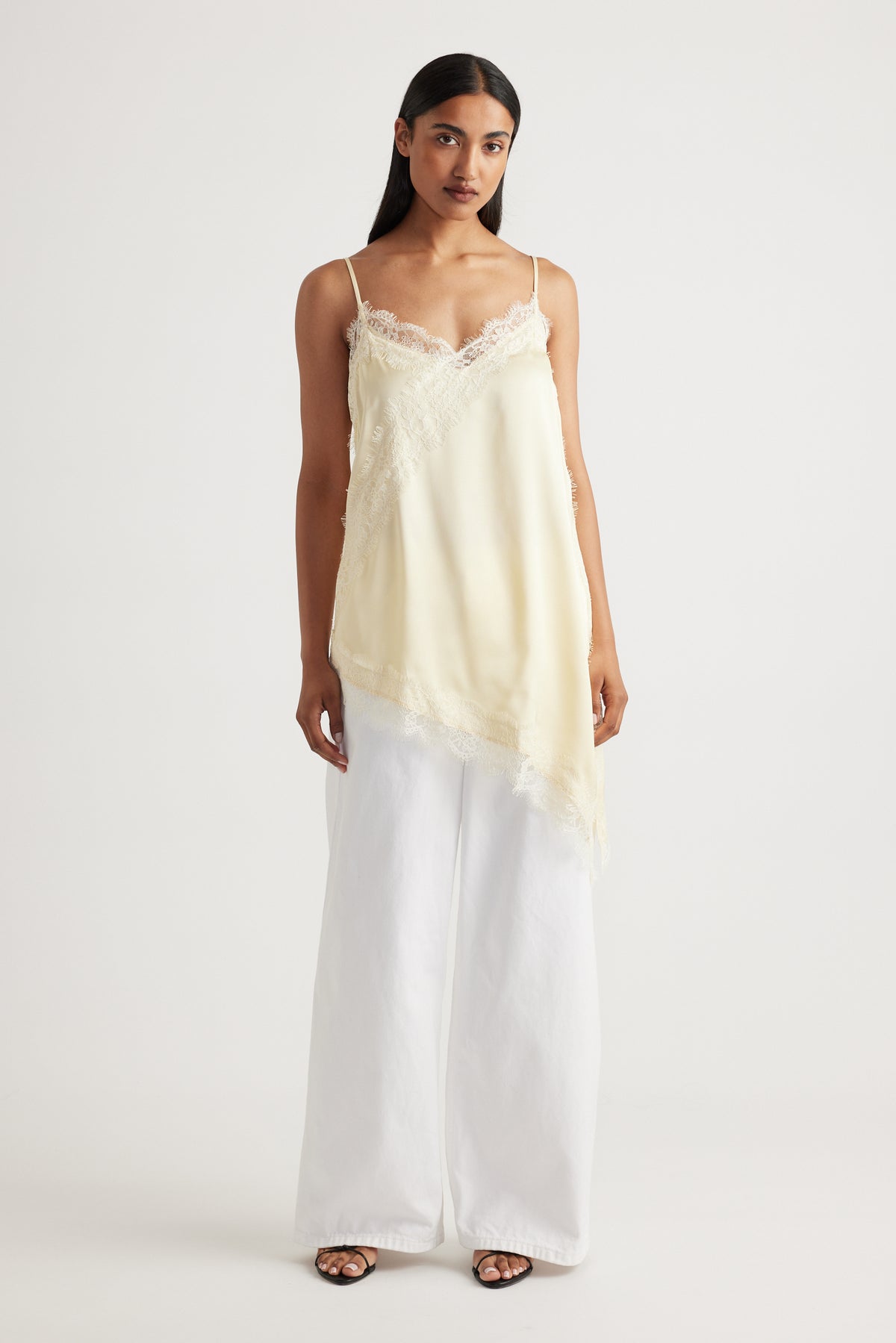 Woman wearing Karla Lace Tunic in cream with delicate lace trim, made from 100% viscose and nylon by DECJUBA Australian brand
