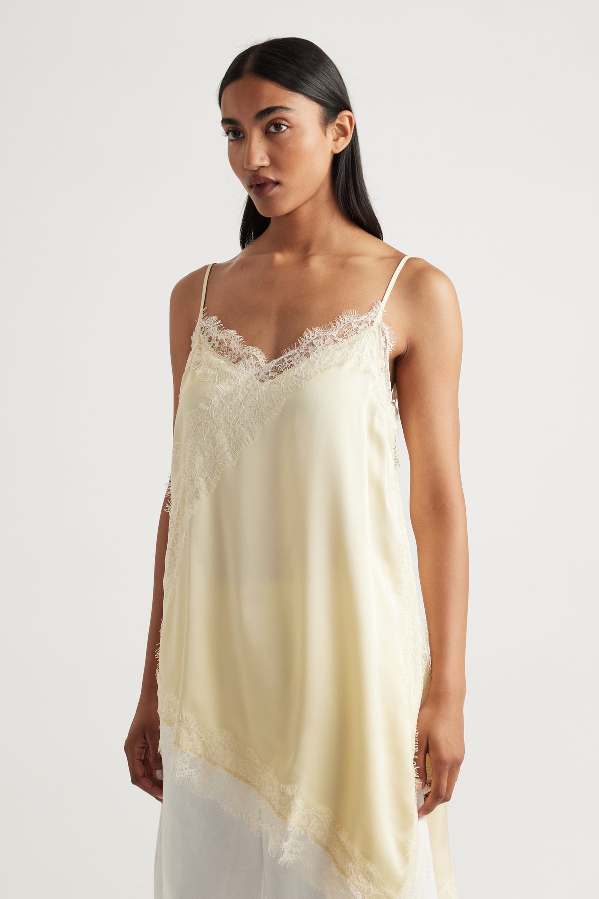 Woman wearing Karla Lace Tunic in soft cream with delicate lace trim, made from 100% viscose and nylon by DECJUBA Australian brand