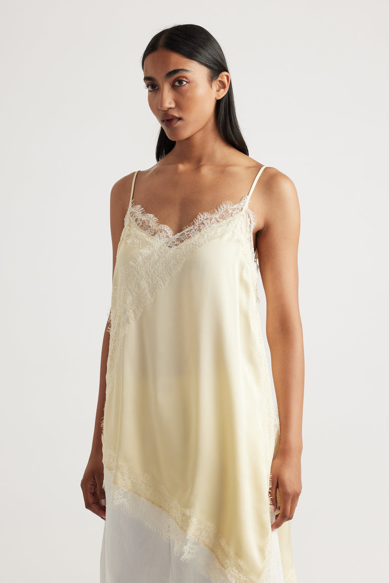 Woman wearing Karla Lace Tunic in soft cream with delicate lace trim, made from 100% viscose and nylon by DECJUBA Australian brand
