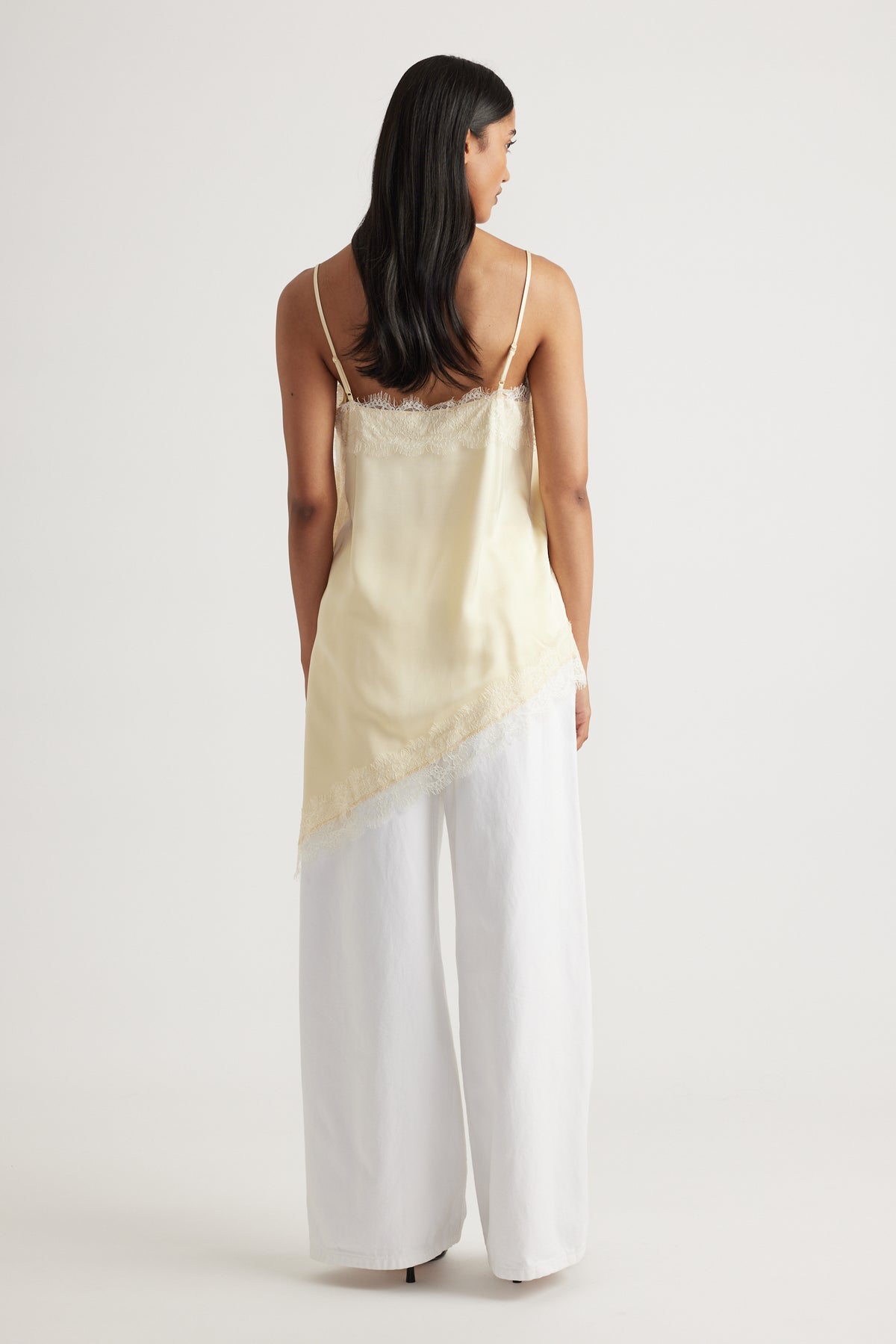 Back view of woman wearing Karla Lace Tunic in soft cream with lace trim, made from 100% viscose by DECJUBA Australian brand